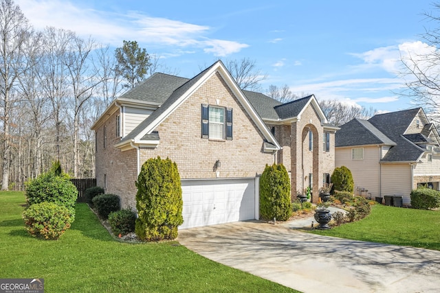 view of side of home featuring a yard, concrete driveway, an attached garage, a shingled roof, and brick siding