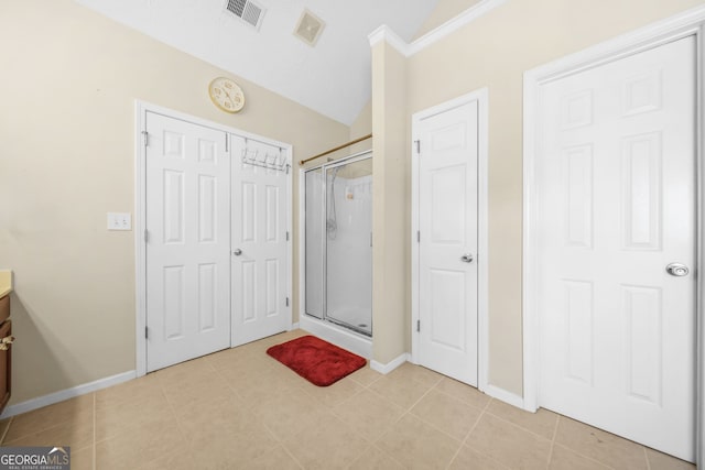 bathroom featuring vanity, a shower stall, visible vents, and tile patterned floors