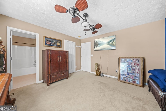 bedroom featuring baseboards, a textured ceiling, a ceiling fan, and carpet floors