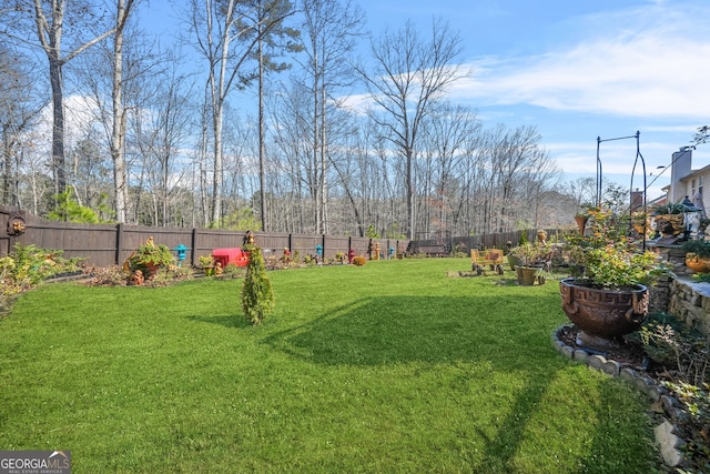 view of yard with a fenced backyard