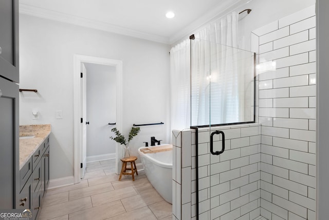 bathroom featuring a stall shower, baseboards, a freestanding tub, vanity, and ornamental molding