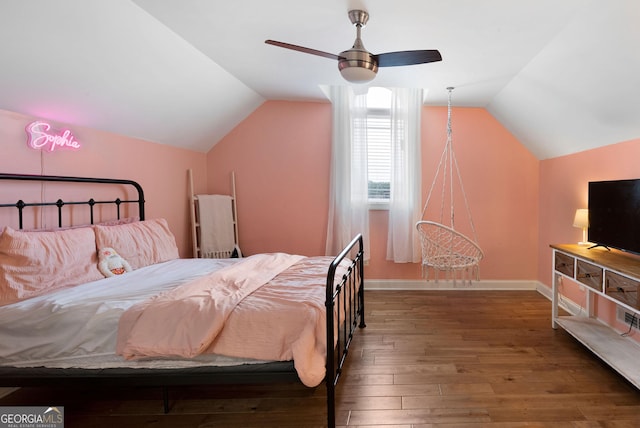 bedroom with baseboards, lofted ceiling, a ceiling fan, and hardwood / wood-style flooring