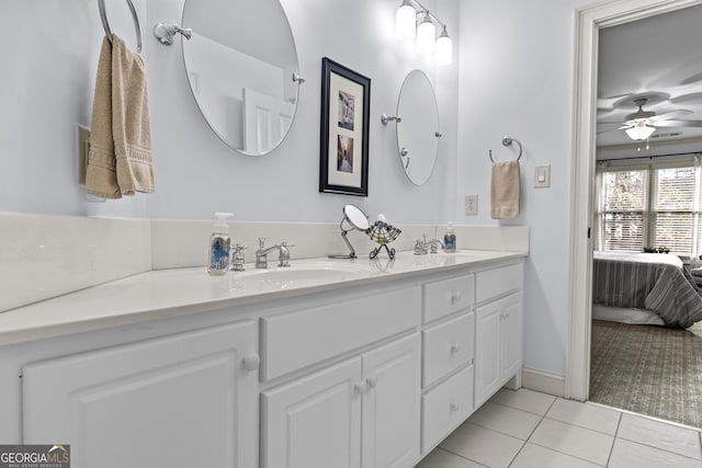 ensuite bathroom with a sink, ensuite bath, tile patterned flooring, double vanity, and ceiling fan