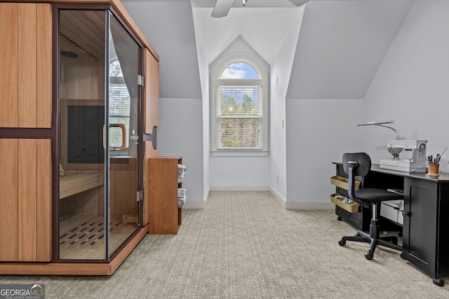 home office with baseboards, a sauna, ceiling fan, vaulted ceiling, and light carpet