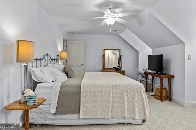 carpeted bedroom with lofted ceiling, a ceiling fan, baseboards, and visible vents