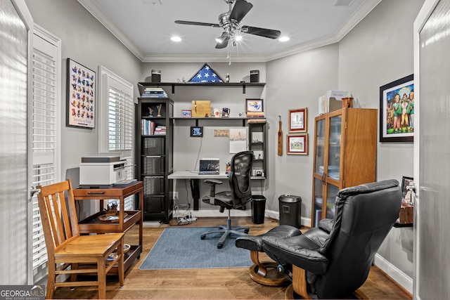 office area with wood finished floors, visible vents, baseboards, ceiling fan, and ornamental molding