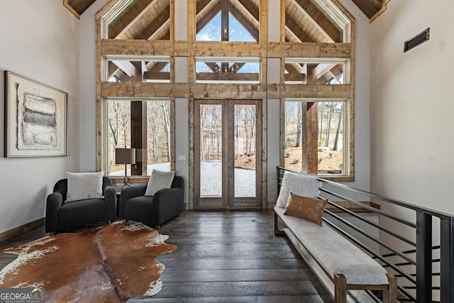 interior space featuring french doors, visible vents, and vaulted ceiling