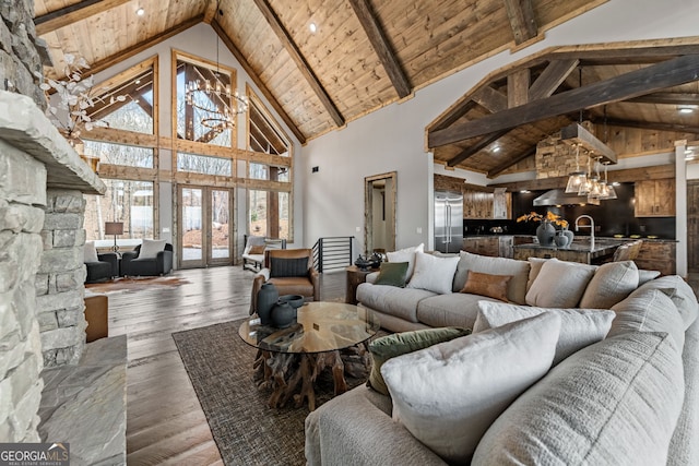 living room with a wealth of natural light, a chandelier, wood ceiling, and hardwood / wood-style flooring