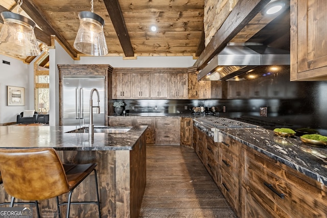 kitchen featuring stainless steel appliances, wooden ceiling, wall chimney exhaust hood, backsplash, and a center island