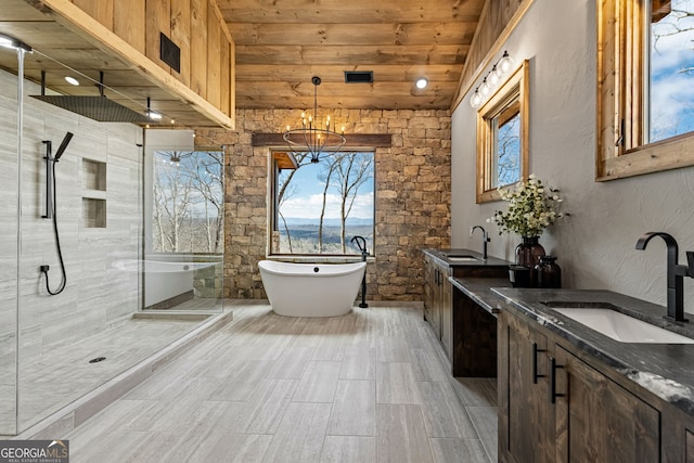 bathroom featuring wood ceiling, double vanity, a stall shower, a soaking tub, and a sink