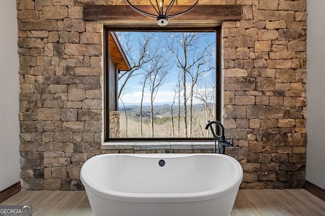 full bathroom with a soaking tub and wood tiled floor