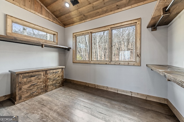 walk in closet featuring visible vents, hardwood / wood-style flooring, and vaulted ceiling