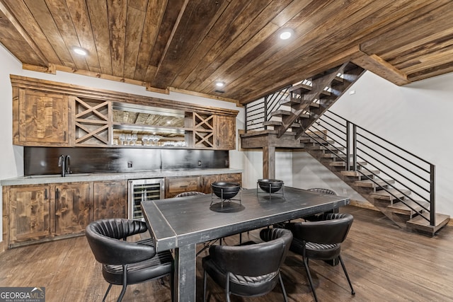 dining area with beverage cooler, wood finished floors, stairway, wooden ceiling, and wet bar