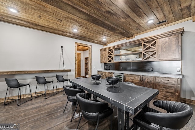 dining room with visible vents, beverage cooler, bar area, wood ceiling, and dark wood-style flooring