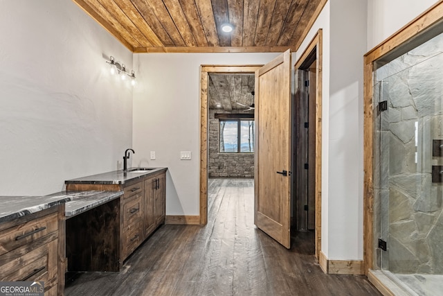 bathroom with a marble finish shower, baseboards, wooden ceiling, wood finished floors, and vanity