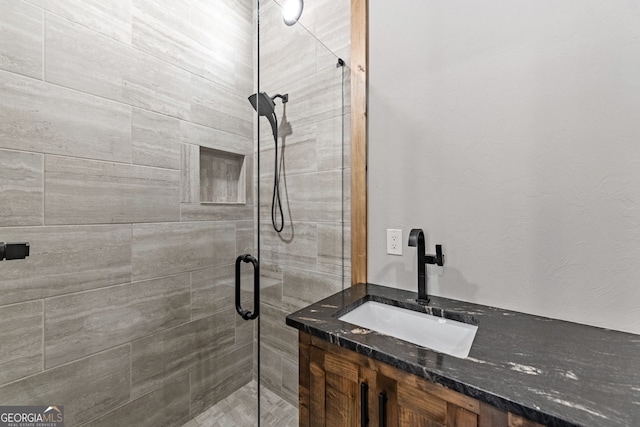 bathroom featuring vanity and a shower stall