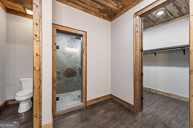 bathroom with a marble finish shower, wood finished floors, baseboards, and wooden ceiling