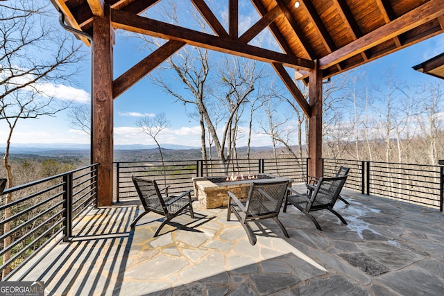 view of patio featuring a mountain view and an outdoor fire pit