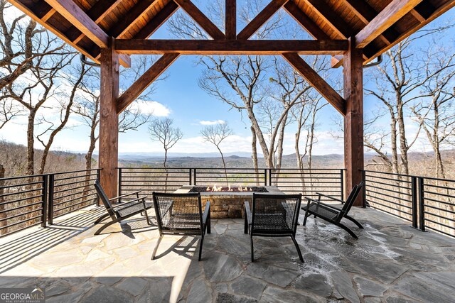 view of patio featuring an outdoor living space with a fire pit