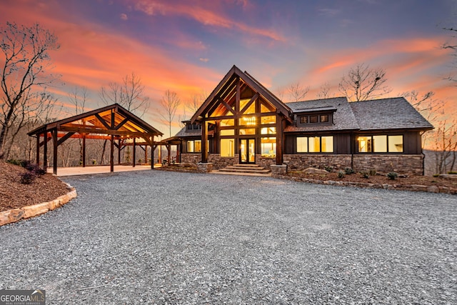 view of front of home featuring stone siding and driveway