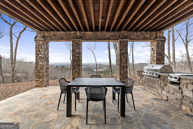 view of patio / terrace with area for grilling, outdoor dining space, and exterior kitchen