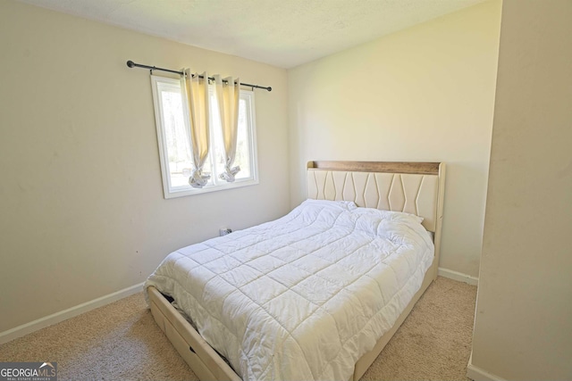 bedroom featuring baseboards and carpet floors