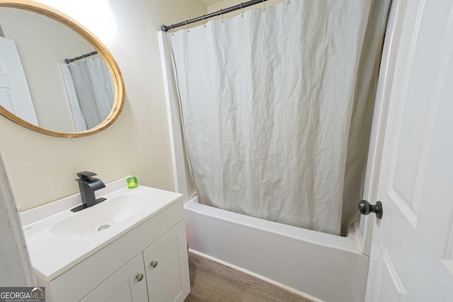 full bath featuring vanity, shower / tub combo with curtain, and wood finished floors