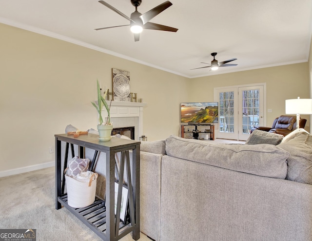 living area with light carpet, ceiling fan, and ornamental molding