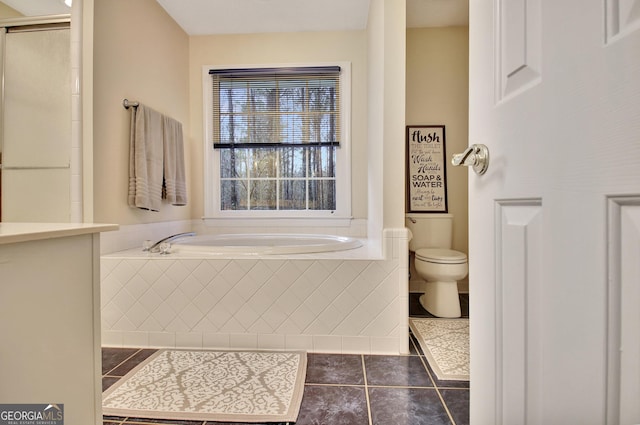 bathroom featuring tile patterned floors, walk in shower, toilet, and a garden tub