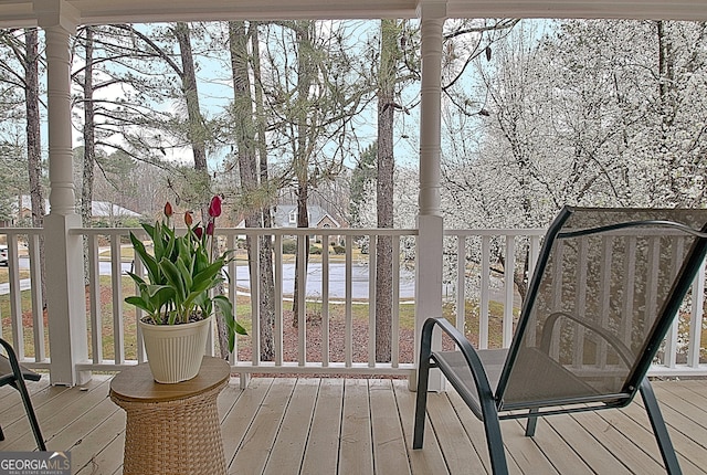 wooden deck featuring a water view