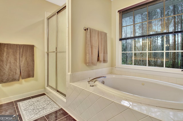 full bathroom with tile patterned flooring, a shower stall, and a garden tub