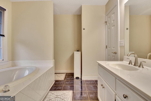 bathroom featuring baseboards, vanity, a garden tub, tile patterned floors, and a textured ceiling