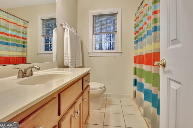 bathroom with tile patterned floors, a shower with shower curtain, toilet, and vanity