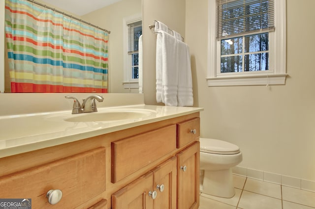 full bath with toilet, curtained shower, tile patterned flooring, baseboards, and vanity