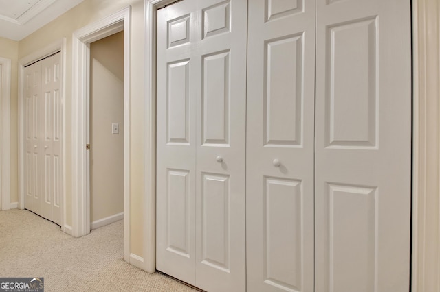 hall with baseboards and carpet floors