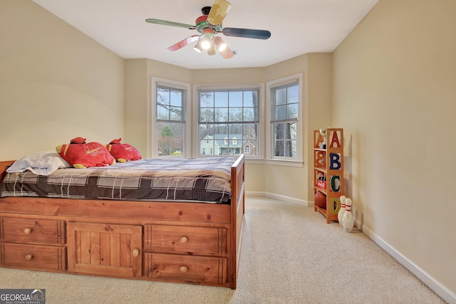 bedroom with ceiling fan, baseboards, and light carpet