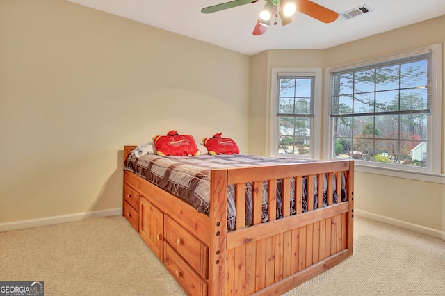 bedroom featuring visible vents, baseboards, and light colored carpet