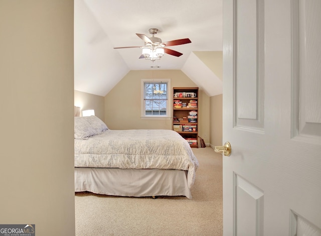 carpeted bedroom featuring lofted ceiling and a ceiling fan