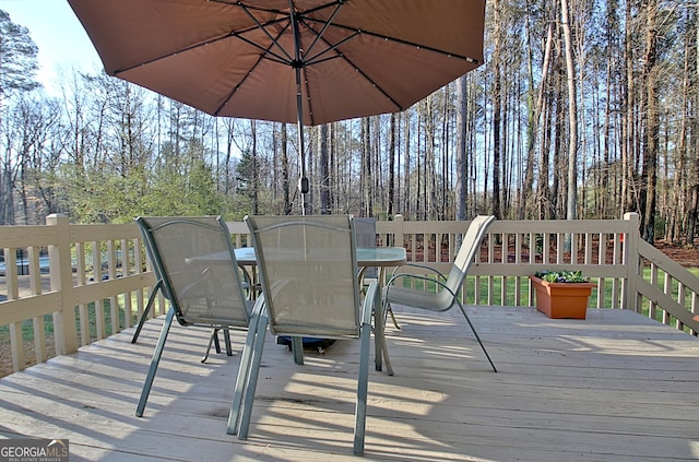 wooden terrace with outdoor dining area