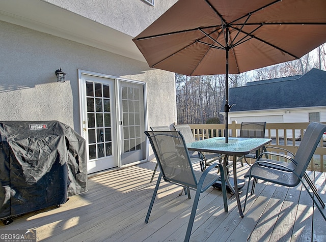 deck with area for grilling and outdoor dining area