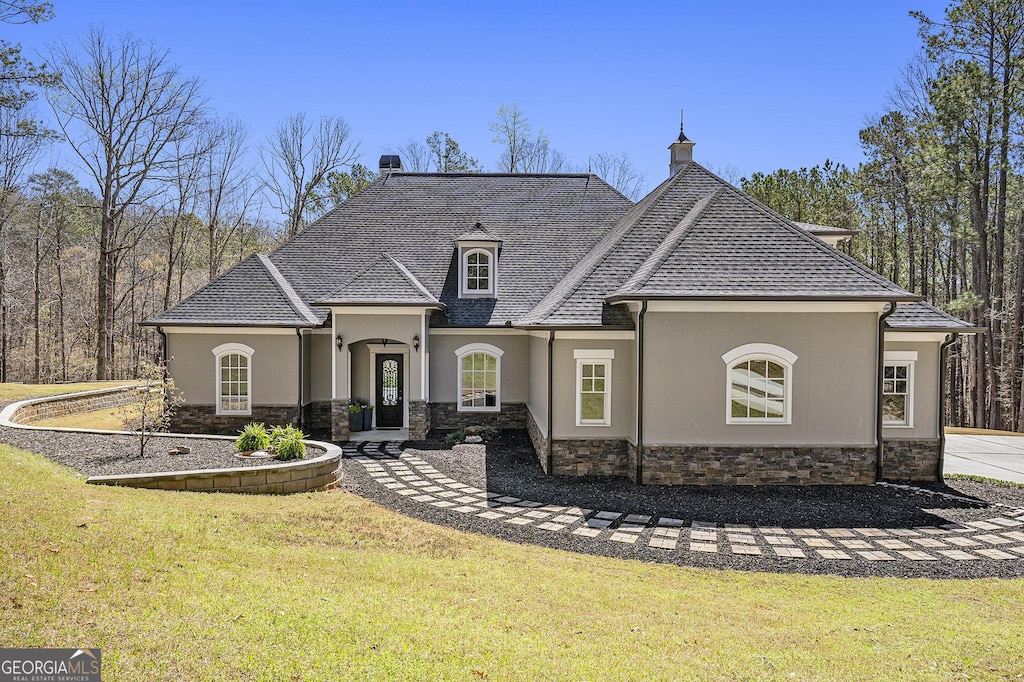 3141 Buck Branch Rd SW, Conyers, GA 30094 - back of house featuring stone siding, a chimney, stucco siding, and a lawn