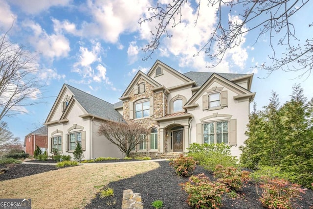 view of front of property featuring stone siding and stucco siding