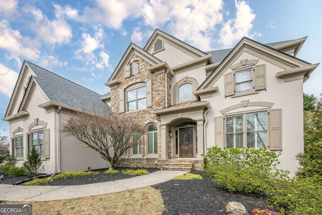 view of front of home with stone siding and stucco siding