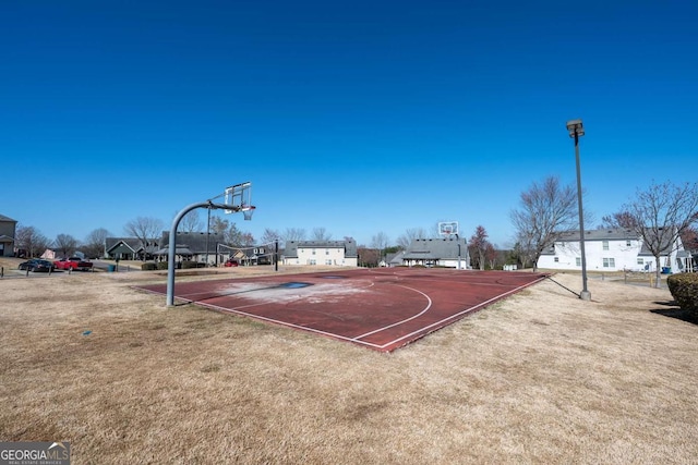 view of sport court with a residential view, community basketball court, and a yard