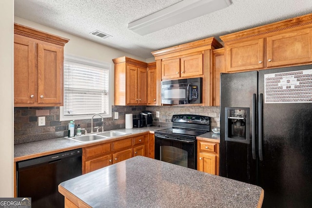 kitchen with tasteful backsplash, visible vents, black appliances, and a sink