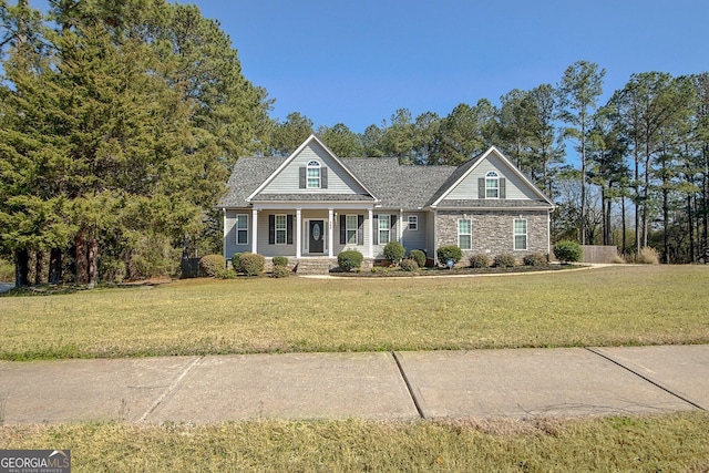 view of front of house with stone siding and a front yard