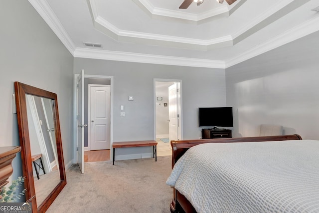 bedroom with a raised ceiling, carpet flooring, crown molding, and baseboards