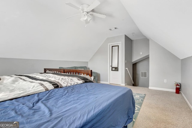 carpeted bedroom featuring vaulted ceiling, baseboards, and visible vents