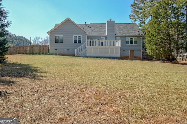 back of house featuring a lawn, fence, a shingled roof, crawl space, and a chimney