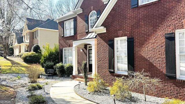 view of property exterior featuring brick siding